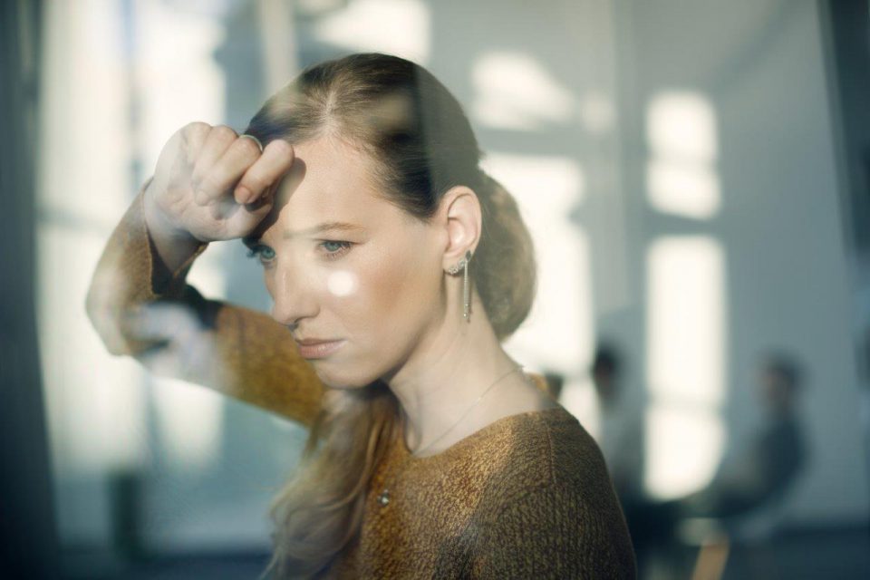 young-sad-woman-leaning-window-looking-through-it
